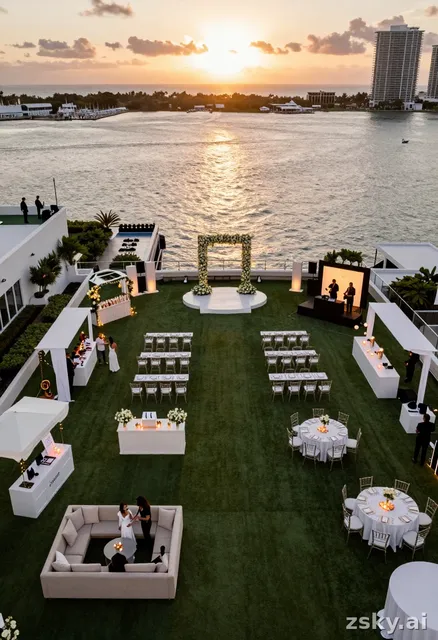 Ultra realistic aerial view of a luxury coastal rooftop wedding festival in Miami at sunset, ocean and marina visible…
